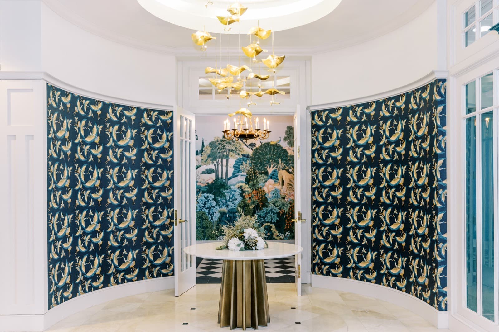 The curved entryway at The Spiral Staircase, with a gold chandelier