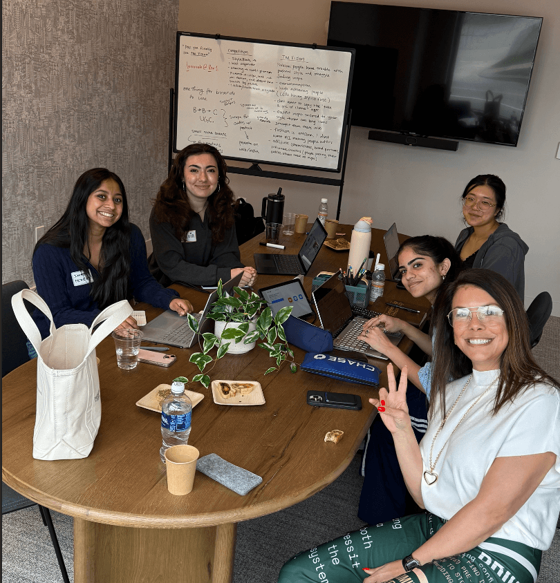 A team of founders working together around a table at Startup Weekend